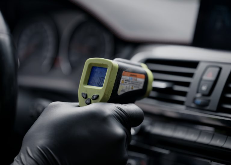 Mechanic servicing car air conditioning in Langley BC
