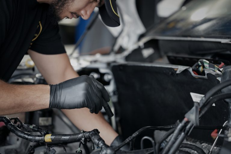 Mechanic diagnosing engine issues at House of Cars Auto Repair Langley BC